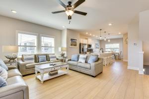 a living room with couches and a dining room at Easy Beach Access New PCB Retreat with Resort Pool! in Panama City Beach