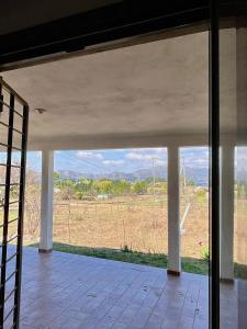 a view from the inside of a house looking out at a field at Cabaña El Balcón in La Estancia
