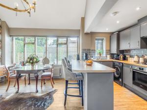a kitchen and dining room with a table and chairs at Dovecote Cottage in Downham Market
