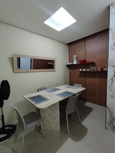 a dining room with a table and some chairs at Suíte Nazaré in Belém