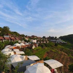 a bunch of white tents on top of a hill at Phutonso Homestay in Chiang Mai