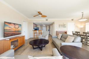 a living room with a couch and a tv at 3BR Luxury Penthouse Panoramic Views in St Pete Beach