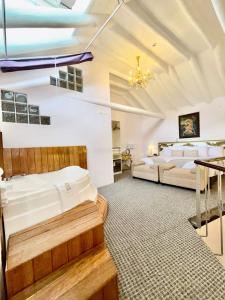 a large bedroom with two beds and a table at Ayni Boutique Hotel in Cusco +28 photos