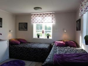 a bedroom with two beds and a window at 6 person holiday home in LYSEKIL in Torgestad