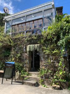 a building with a sign in front of it at 九份山海灣民宿 I 近老街 l 海景檜木房 in Jiufen