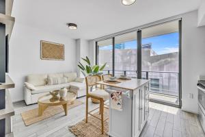a kitchen and living room with a couch and a table at Luxury High-Rise Condo in Downtown Miami - Pool and Gym in Miami