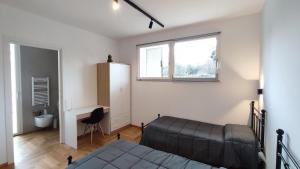 a bedroom with a bed and a desk and a window at Appartamento tra mare e montagna in Castel di Lama +3 photos