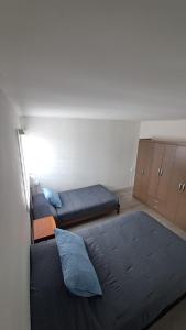 a room with two beds and cabinets in it at Hospedaje - Apart Hotel Las Higueras Talcahuano in Talcahuano