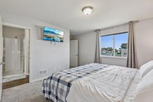 a bedroom with a bed and a window at Valclyde Signature Home in Big Lake