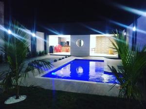 a swimming pool at night with blue lights at Private pool, spacious, barbecue in Londrina