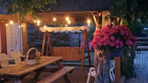 a patio with a wooden table and a tree with flowers at Luxury Family House 3 beds, 1 bath, 5 guest in Toronto