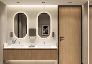 a bathroom with two sinks and two mirrors at Radisson Hotel Amsterdam Schiphol Airport Hoofddorp in Hoofddorp +51 photos