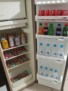 an open refrigerator filled with lots of drinks and soda at No jardim in Pomerode