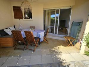 a dining room with a table and chairs in a kitchen at Ravissant T2 aux Issambres avec Piscine et Climatisation - FR-1-768-126 in La Garonnette-Plage
