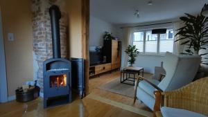 a living room with a wood burning stove in it at Ferienhaus Landblick in Bad Arolsen