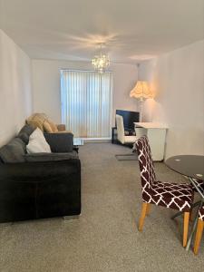 a living room with a couch and a giraffe chair at The Flat in Monmore Green