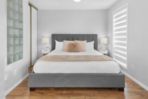 a bedroom with a large bed and two lamps at Fabulous Home-King bed-Easy Access to EVERyTHING! in Edmonton