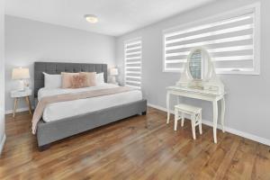 a bedroom with a bed and a table and a mirror at Fabulous Home-King bed-Easy Access to EVERyTHING! in Edmonton