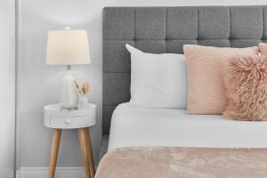 a bedroom with a bed with a lamp on a side table at Fabulous Home-King bed-Easy Access to EVERyTHING! in Edmonton