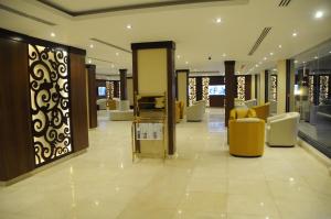 a lobby with yellow and white furniture in a store at Shally Residence For Serviced Apartment 1 in Al Khobar