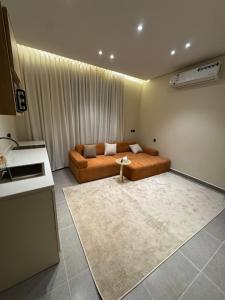 a living room with a bed and a table in it at Luxury studio in Al-ʿUla +6 photos
