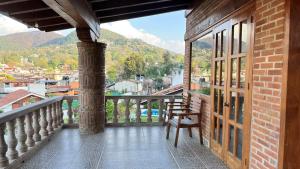 a balcony with a chair and a view of a city at Casa Zaragoza in Valle de Bravo