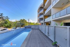 a swimming pool in front of a building at The Skyline Lookout 2 Bd Apt in Stuart Park