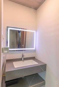 a bathroom with a sink and a mirror at Cocohome Đà Lạt - Villa & Homestay Best Price in Ấp Ða Lợi