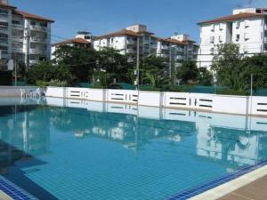 a large blue swimming pool with buildings in the background at Great Value Residence in Bangna