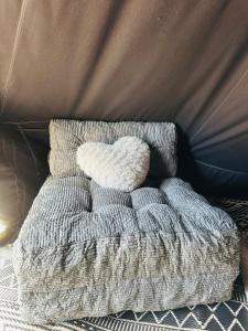 a white pillow sitting on top of a bed at Rocky Ridge Glamping Yosemite in Coarsegold