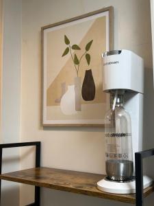 a coffee maker sitting on a table with a picture at COMMA House in Yokohama