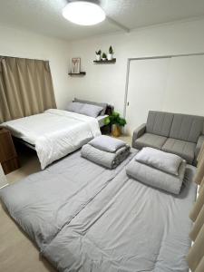 a living room with two beds and a couch at COMMA House in Yokohama +45 photos