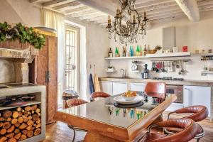 a kitchen with a table and chairs in a room at Tuscan Country House With Pool And Spa in Capolona