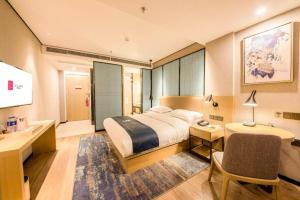 a bedroom with a large bed and a bathroom at Echarm Hotel Fuzhou Sanfang Qixiang East Street Metro Station in Fuzhou +215 photos
