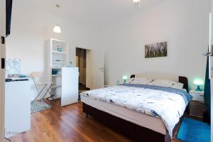 a bedroom with a bed and a desk with a chair at George Apartment in Zagreb