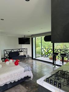 a bedroom with a bed and a stove in a room at Cabaña Yará in Dosquebradas