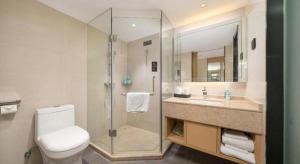 a bathroom with a shower and a toilet and a sink at City Comfort Inn Nanning Exhibition Center Hangyang City Metro Station in Nanning +207 photos