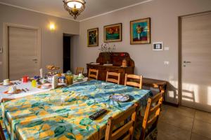 a dining room table with a blue and yellow table cloth at Villa Pizzen Longhi in Invorio Inferiore