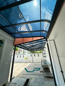 a glass roof on a building with a table at Penang Balik Pulau BBQ & KARAOKE Home in Balik Pulau +3 photos