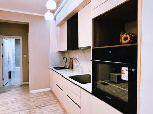a kitchen with a sink and a stove at Cozy furnished Brand-New City Center UB Apartment in Ulaanbaatar +7 photos