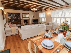 a living room with white furniture and a table at Peary House in Ingram