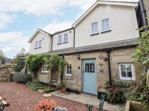 a house with a blue door and a yard at Peary House in Ingram