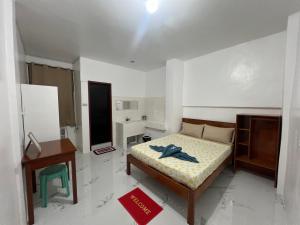 a small bedroom with a bed and a bathroom at Baron Tourist Inn in El Nido