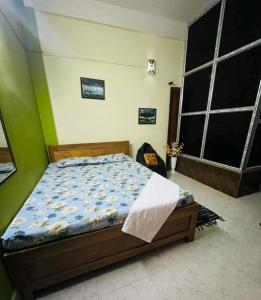 Ένα ή περισσότερα κρεβάτια σε δωμάτιο στο Sangrag Homestay