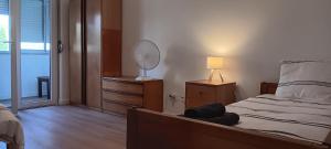 a bedroom with a bed with a mirror and a lamp at CarriCHe 3 in Lisbon