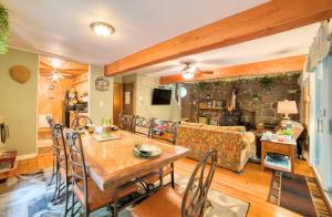 a living room with a table and a couch at 1mi to Lake Wallenpaupack | Firepit | Pet Friendly in Paupack