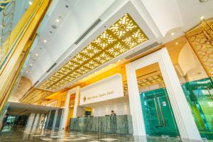 a shopping mall in singapore with a gold ceiling at New Season Square Hotel - SHA Plus in Hat Yai