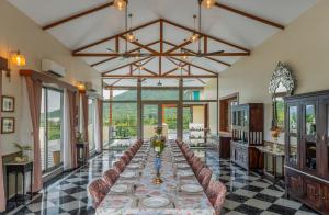a dining room with a long table and chairs at Dilip Niwas in Udaipur +39 photos