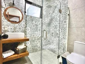 a bathroom with a shower and a sink and a mirror at Cabaña Montez in Puente de las Cuevas +37 photos