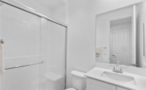 a bathroom with a toilet and a sink and a shower at Rois Yucaipa in Yucaipa